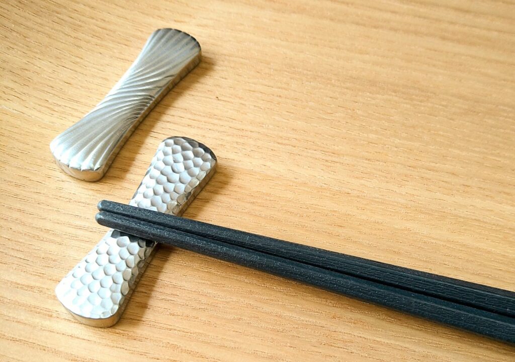 simple black chopstick rest on wooden table