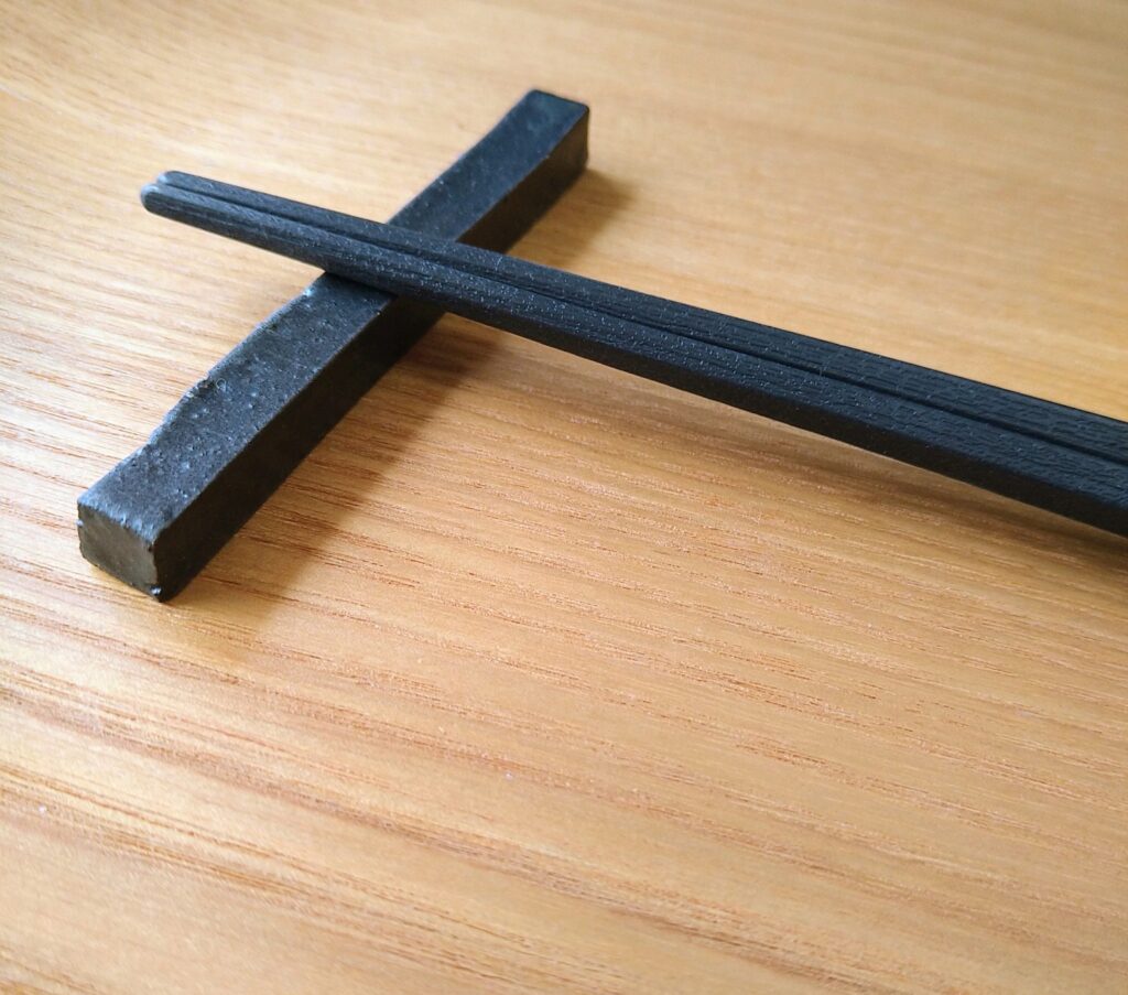 simple black chopstick rest on wooden table